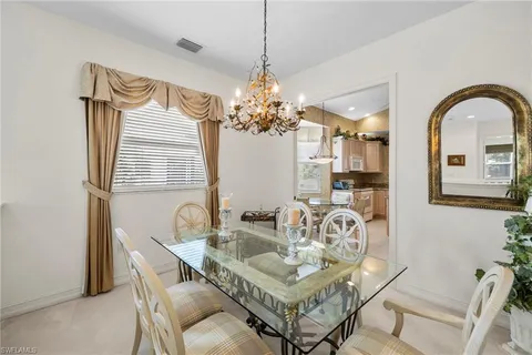 a view of a dining room with furniture and chandelier