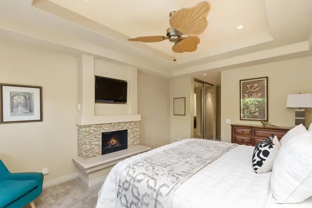 a spacious bedroom with a bed and a flat screen tv