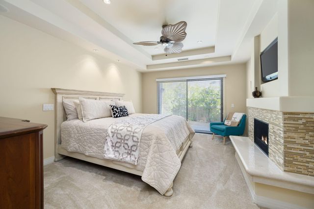 a spacious bedroom with a bed and a fireplace