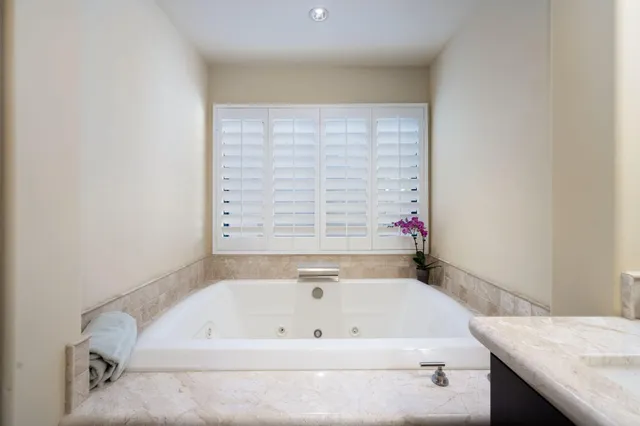 a bathroom with a bathtub and a window