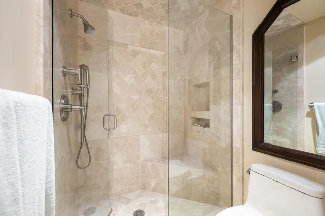a bathroom with a glass shower door