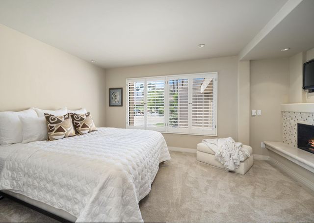 a spacious bedroom with a bed and a fireplace