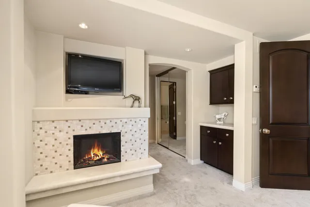 a living room with furniture a flat screen tv and a fireplace