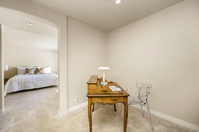 a bedroom with a bed and a table