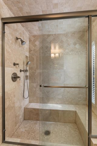 a bathroom with a glass shower door