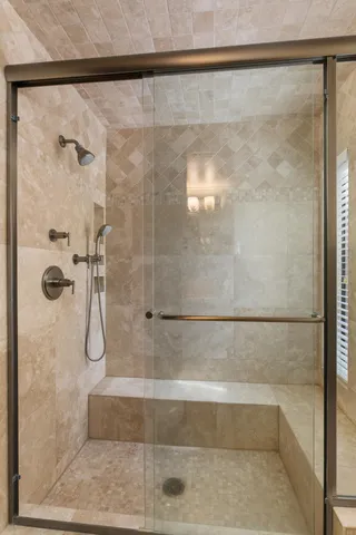 a bathroom with a glass shower door