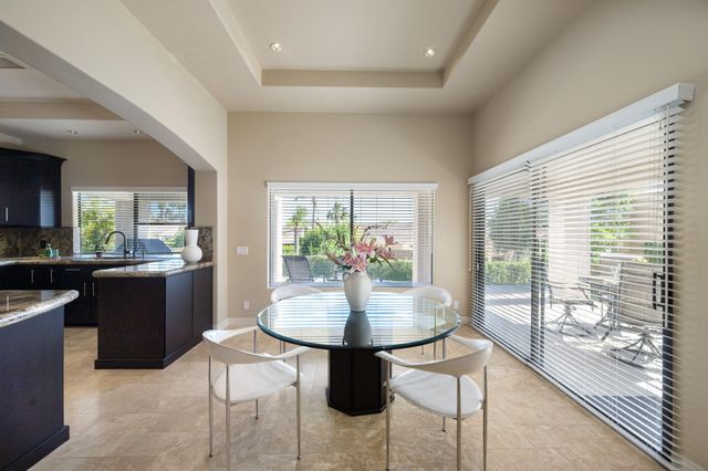 a dining room with wooden floor and glass table