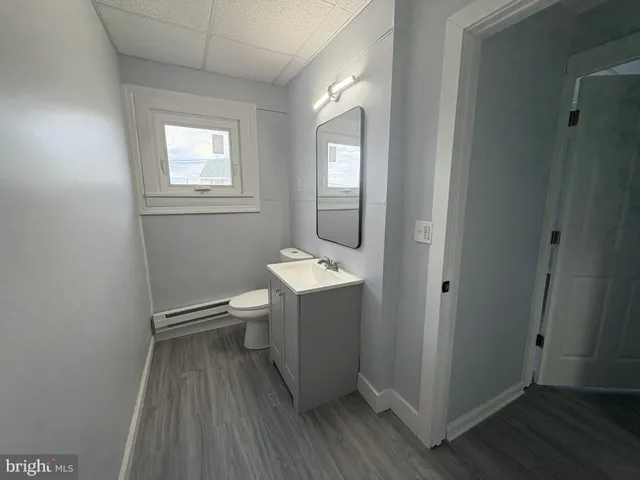 a bathroom with a sink mirror and toilet