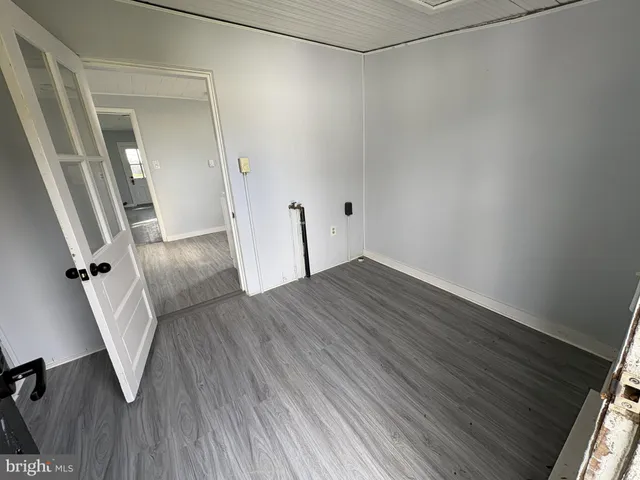 a view of a room with wooden floor and staircase