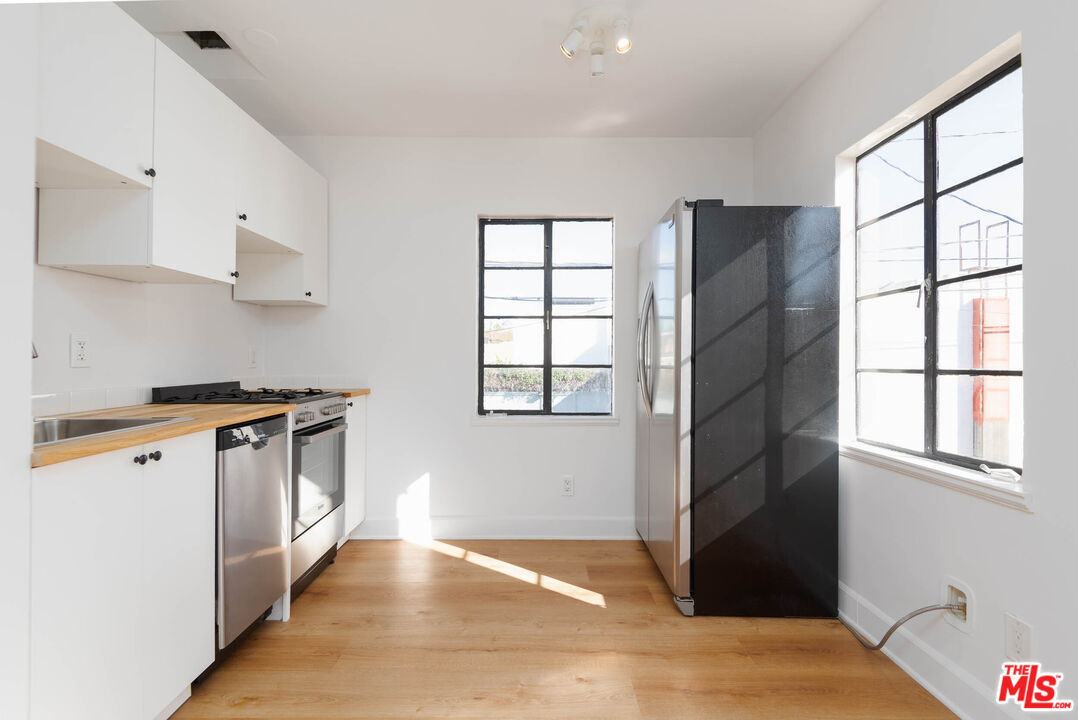 822 North Detroit Street, Unit 826 5 Los Angeles, CA 90046 - Photo 5 of 14 a kitchen with stainless steel appliances granite countertop a refrigerator and a stove
