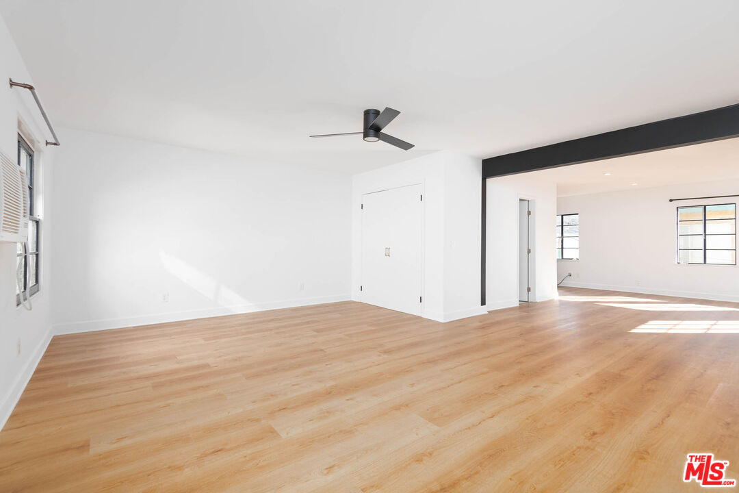 822 North Detroit Street, Unit 826 5 Los Angeles, CA 90046 - Photo 10 of 14 a view of an empty room with wooden floor and a window
