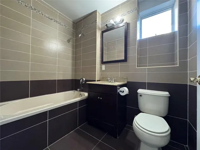 a bathroom with a toilet a sink and mirror