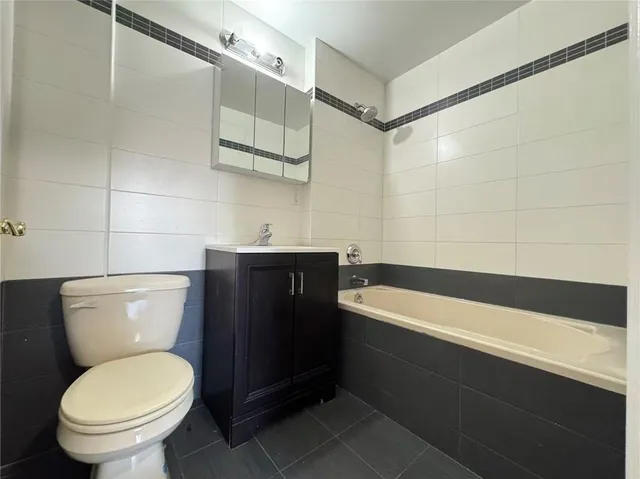 a bathroom with a toilet a sink and bathtub