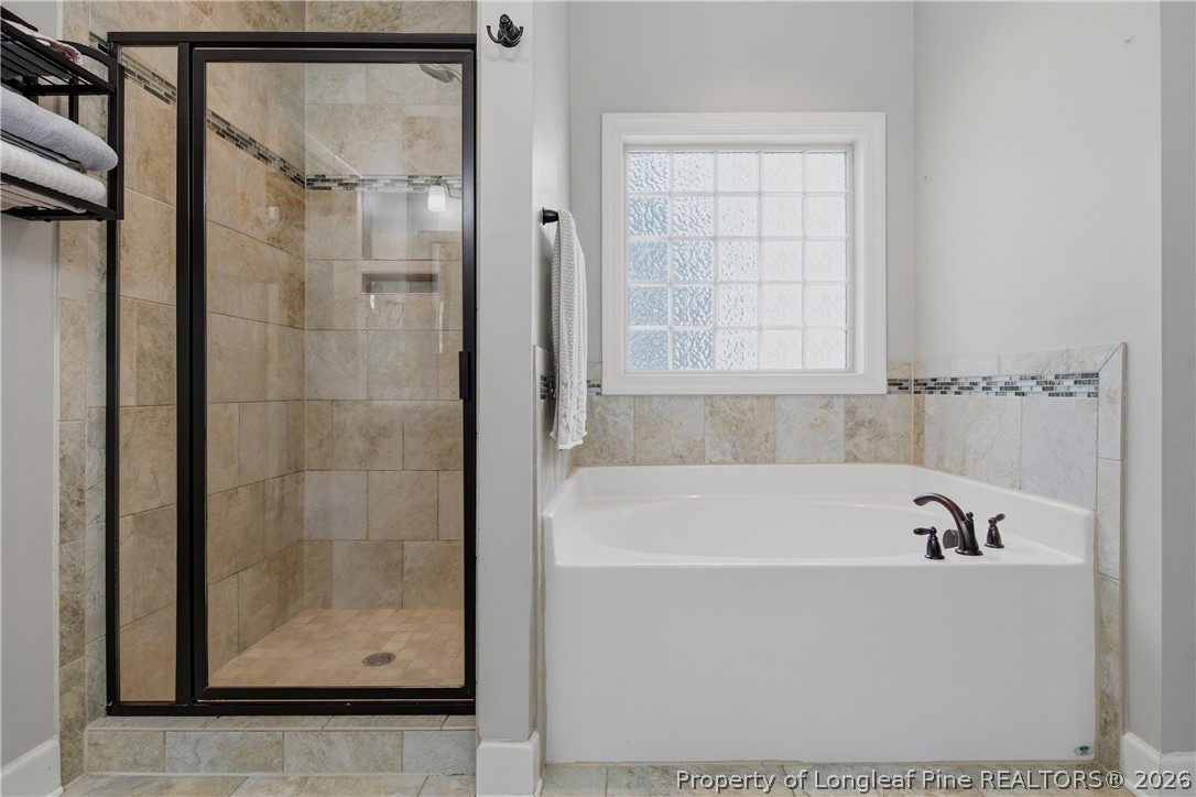 148 Heatherspring Way Spring Lake, NC 28390 - Photo 32 of 50 a bathroom with a bathtub and shower