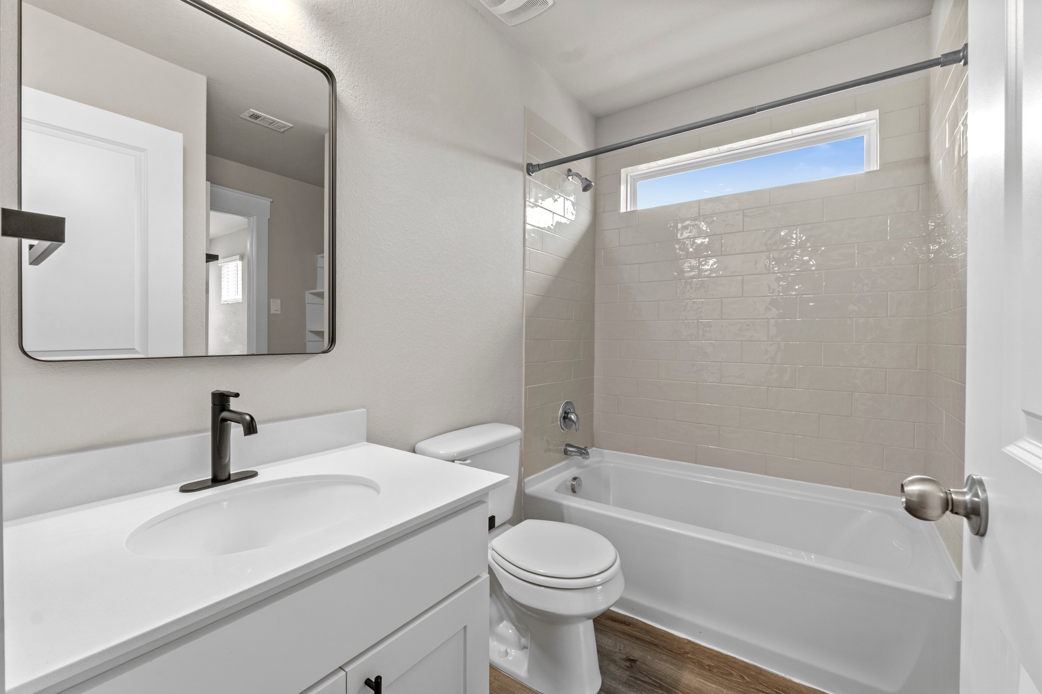 2251 Rocoso Trail Leander, TX 78641 - Photo 23 of 34 Clean lines and a tiled shower tub alcove define this modern bathroom space.