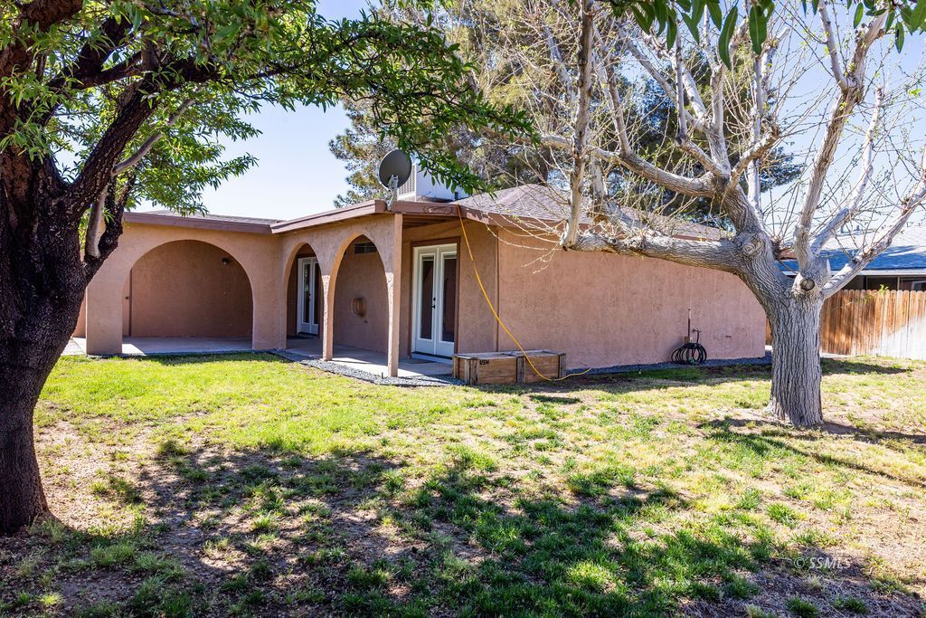 1144 West Benson Avenue Ridgecrest, CA 93555 - Photo 28 of 32 a view of a backyard with large tree