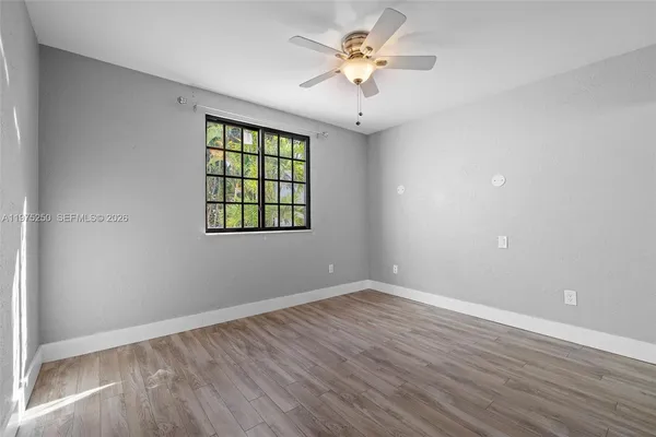 wooden floor in an empty room with a window
