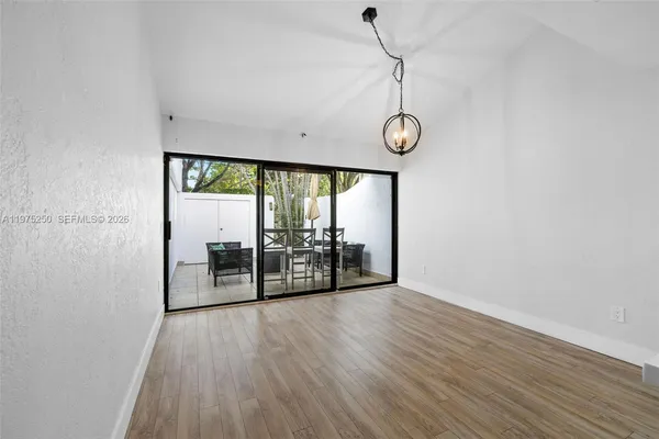 a view of a room with wooden floor and iron gate