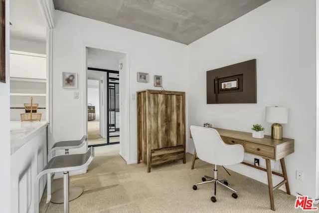 a workspace with furniture and a bathroom