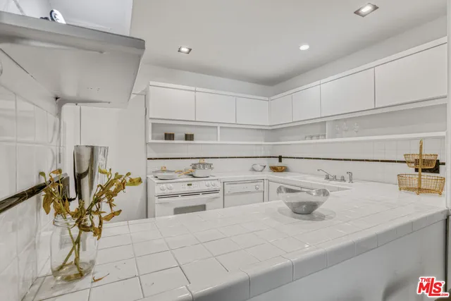 a kitchen with a sink and wooden cabinets