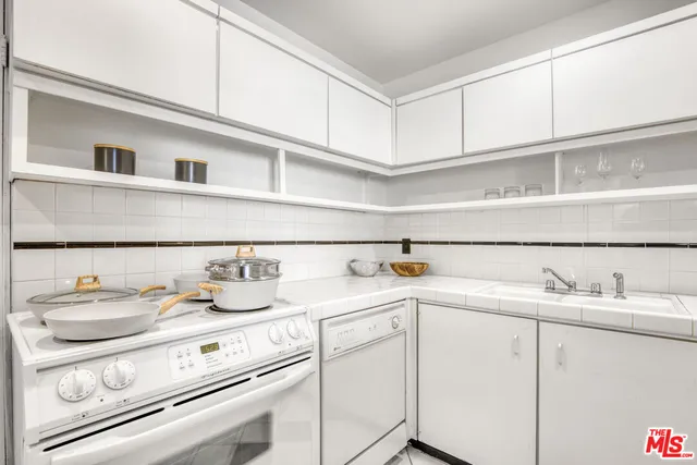 a kitchen with appliances cabinets and a sink