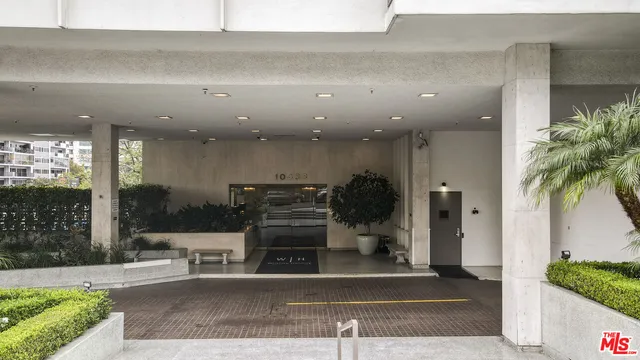 a lobby with furniture and a potted plant