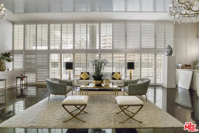 a living room with fireplace furniture and a large window