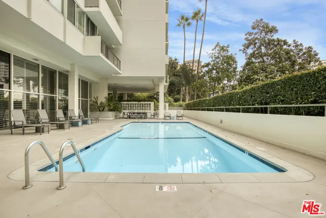 a view of a swimming pool with a lounge chair
