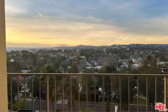 a view of a balcony with a forest