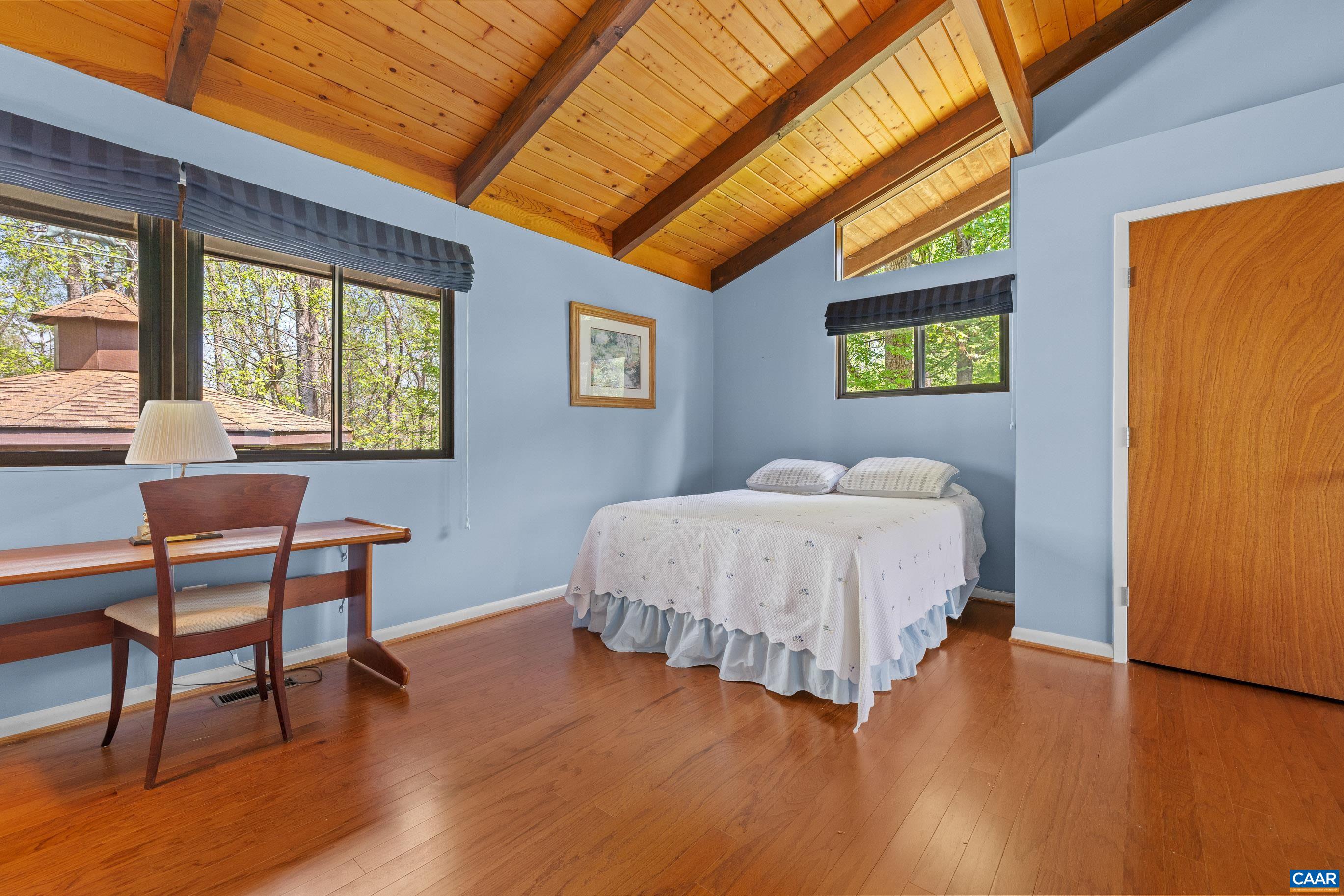 116 Chestnut Ridge Road Charlottesville, VA 22911 - Photo 6 of 63 a bed sitting in a bedroom next to a window
