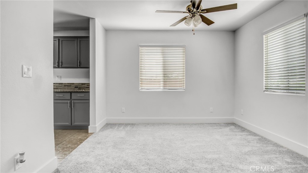 330 East 101st Street Los Angeles, CA 90003 - Photo 7 of 15 an empty room with chandelier fan and windows