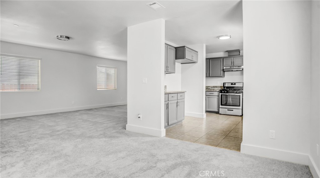 330 East 101st Street Los Angeles, CA 90003 - Photo 9 of 15 an empty room with kitchen appliances and windows