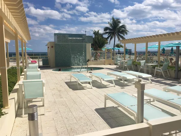 a swimming pool with outdoor seating and yard