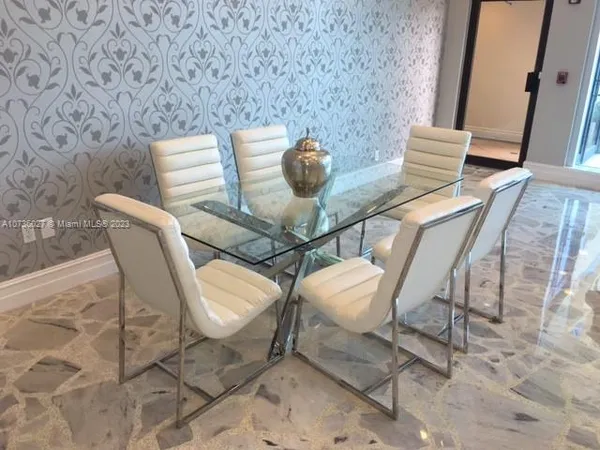 a view of a patio with a table and chairs