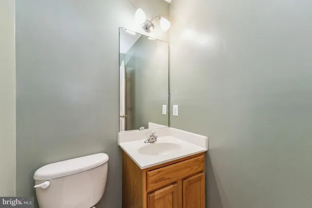 a bathroom with a sink a toilet and mirror