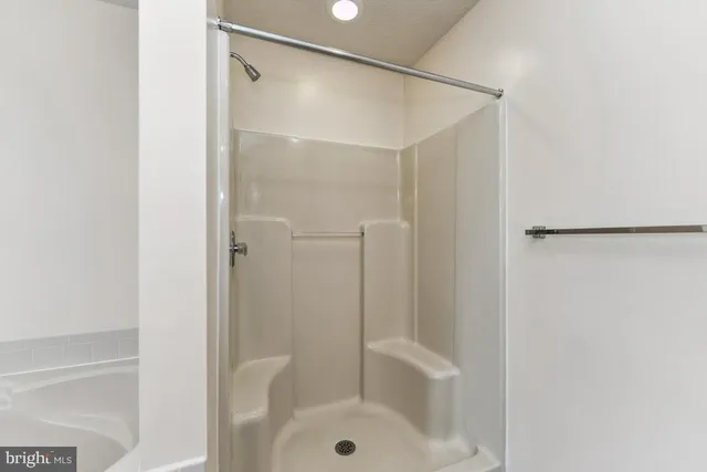 a bathroom with a glass shower door