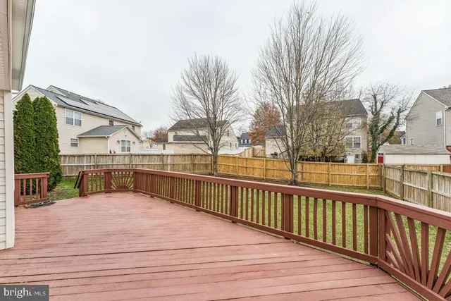 a view of balcony with wooden floor and fence