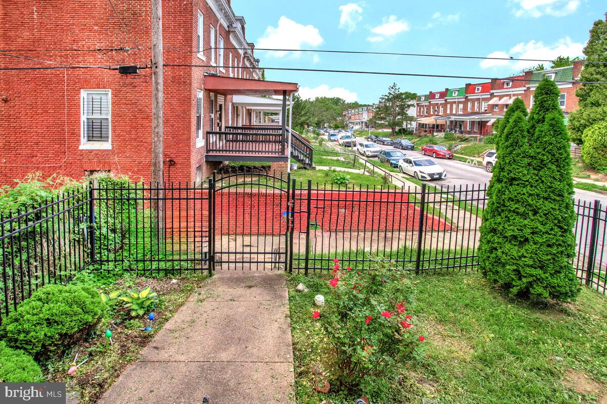 3516 Reisterstown Road Baltimore, MD 21215 - Photo 18 of 21 a view of a house with a small yard and plants
