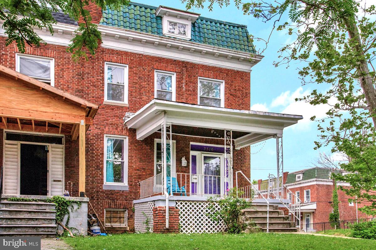 3516 Reisterstown Road Baltimore, MD 21215 - Photo 2 of 21 front view of a brick house with a yard