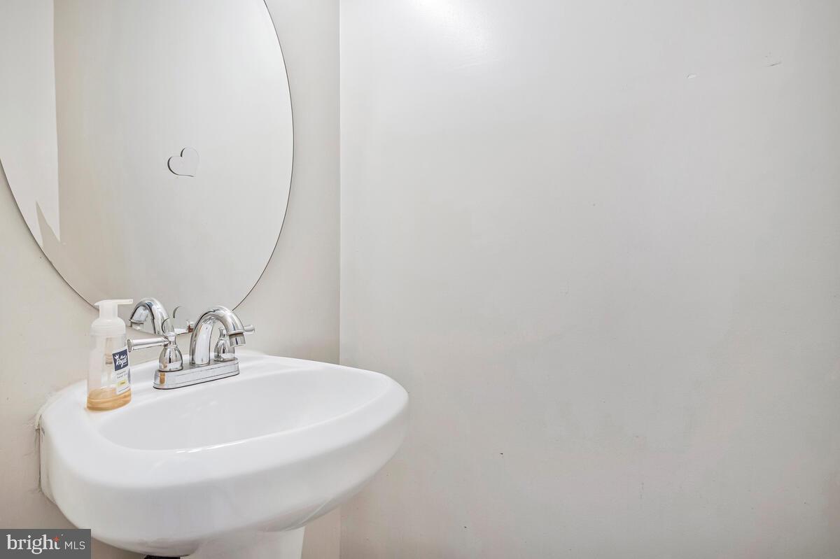 3516 Reisterstown Road Baltimore, MD 21215 - Photo 6 of 21 a bathroom with a sink and a mirror