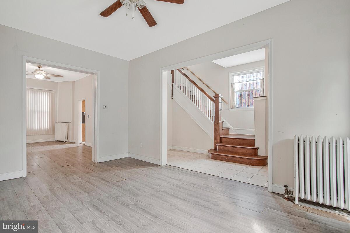 3516 Reisterstown Road Baltimore, MD 21215 - Photo 9 of 21 wooden floor in an empty room with a window
