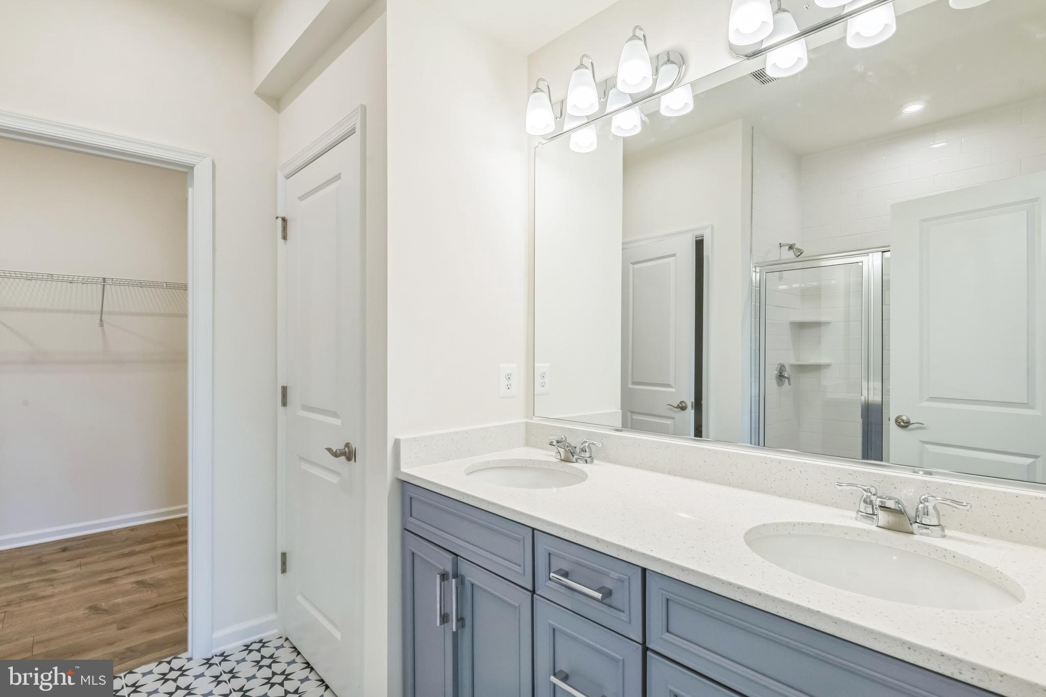 390 Scranton Lane Ocean View, DE 19970 - Photo 11 of 15 a bathroom with a double vanity sink a large mirror and shower