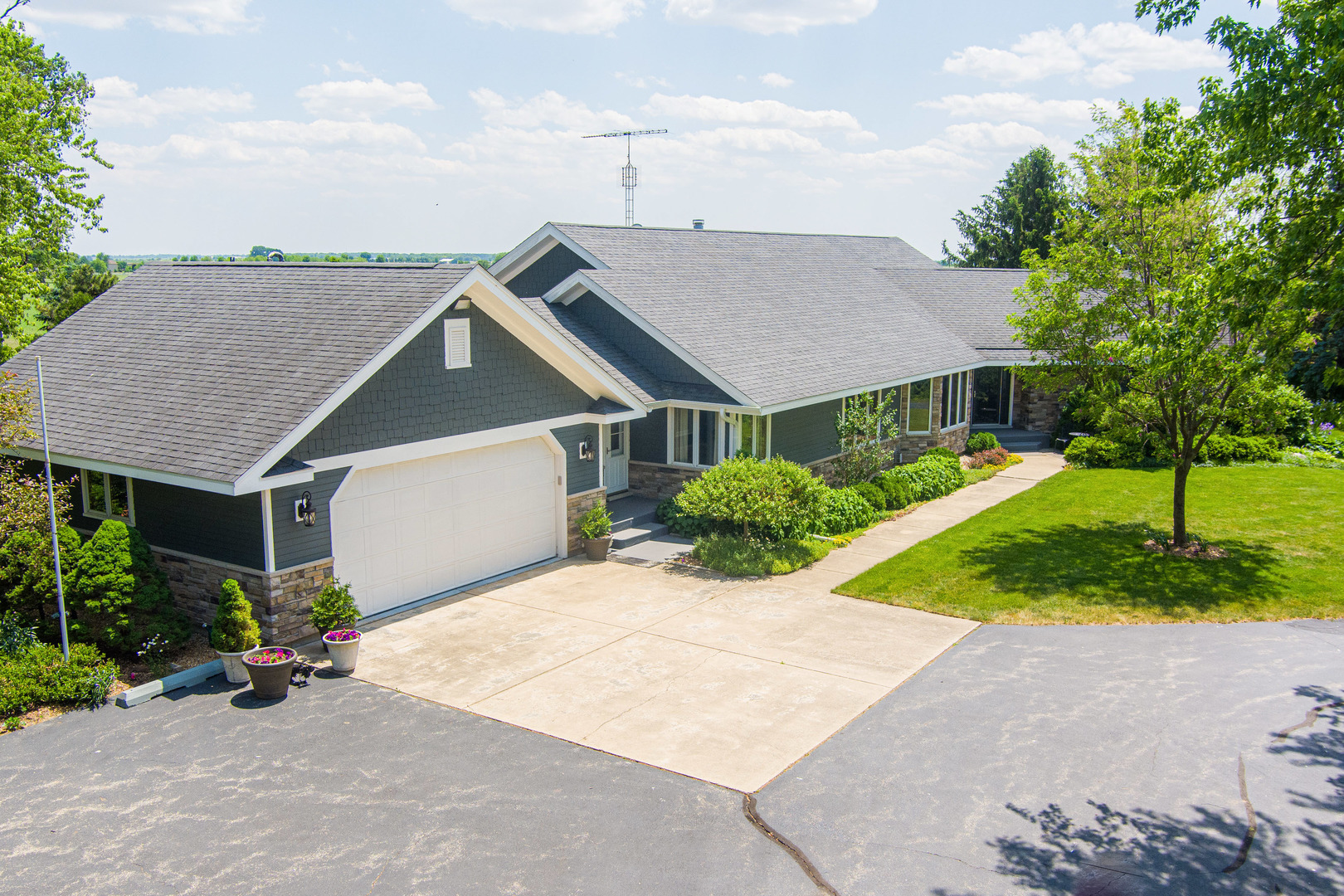 1N409 County Line Road Maple Park, IL 60151 - Photo 3 of 125 a front view of a house with a yard and a garden