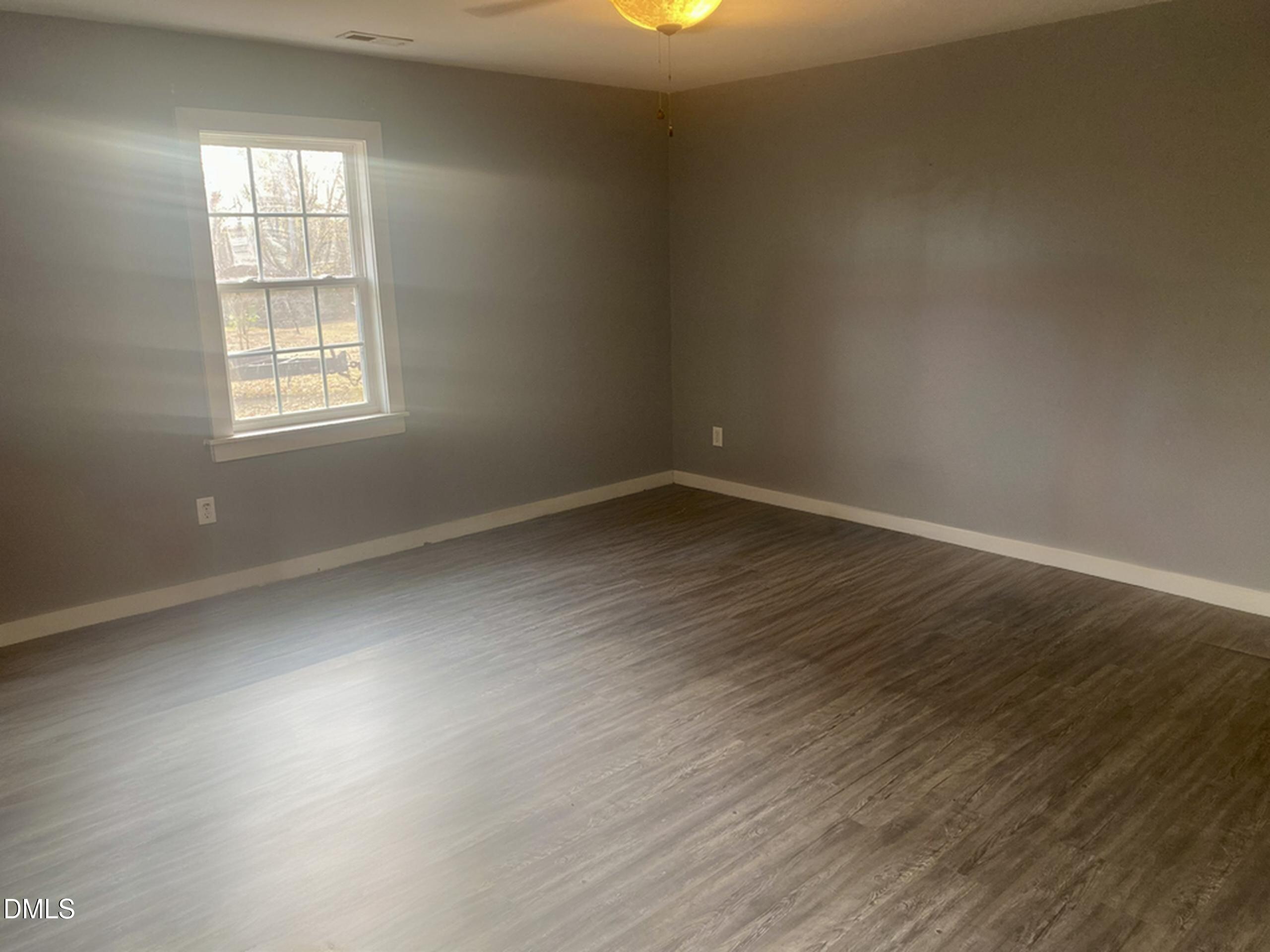 3182 Sims Bridge Road Kittrell, NC 27544 - Photo 25 of 44 an empty room with wooden floor and windows