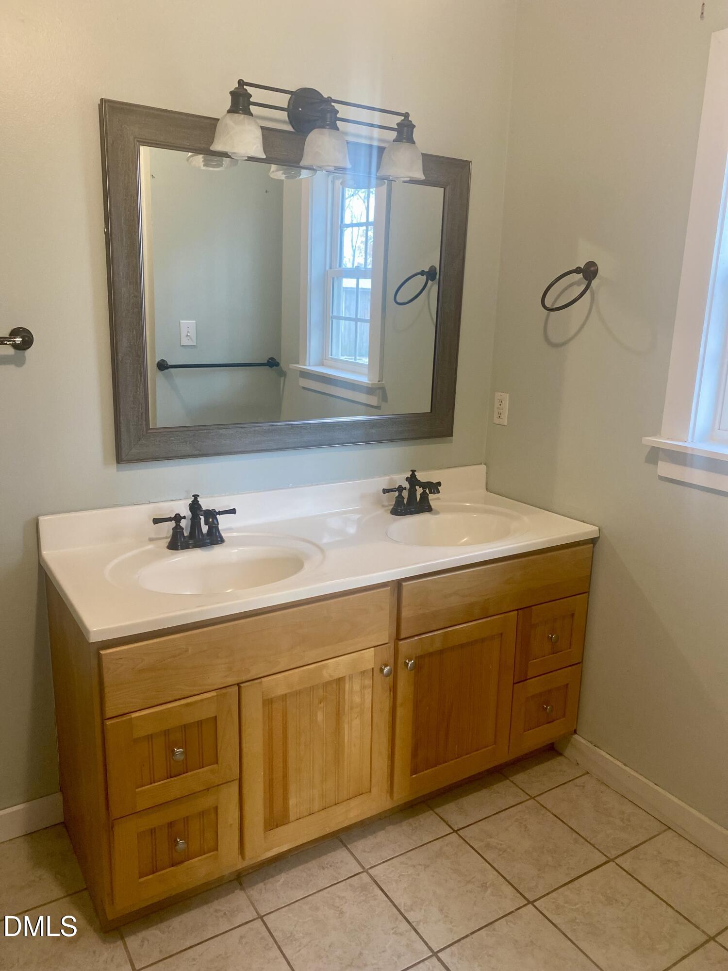 3182 Sims Bridge Road Kittrell, NC 27544 - Photo 31 of 44 a spacious bathroom with a double vanity sink and a mirror