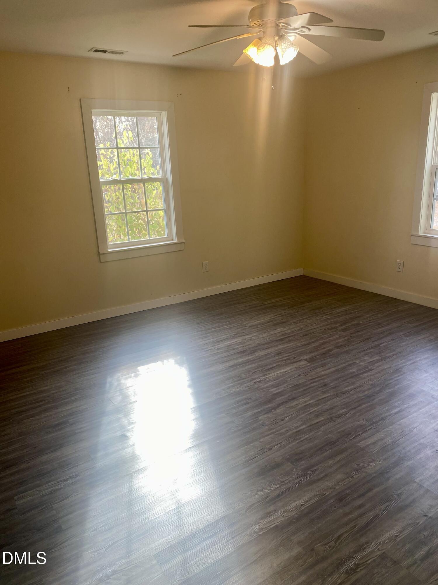 3182 Sims Bridge Road Kittrell, NC 27544 - Photo 34 of 44 an empty room with wooden floor and windows