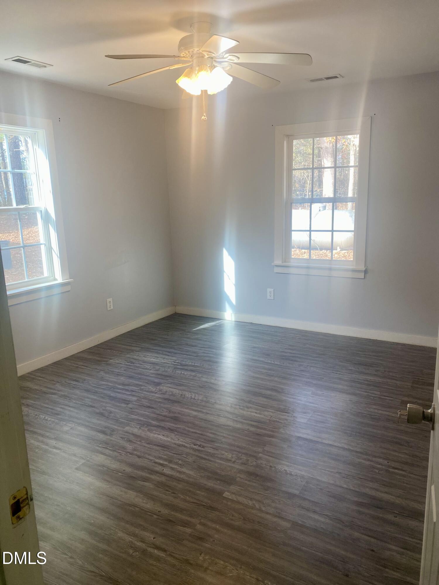 3182 Sims Bridge Road Kittrell, NC 27544 - Photo 36 of 44 an empty room with wooden floor and windows