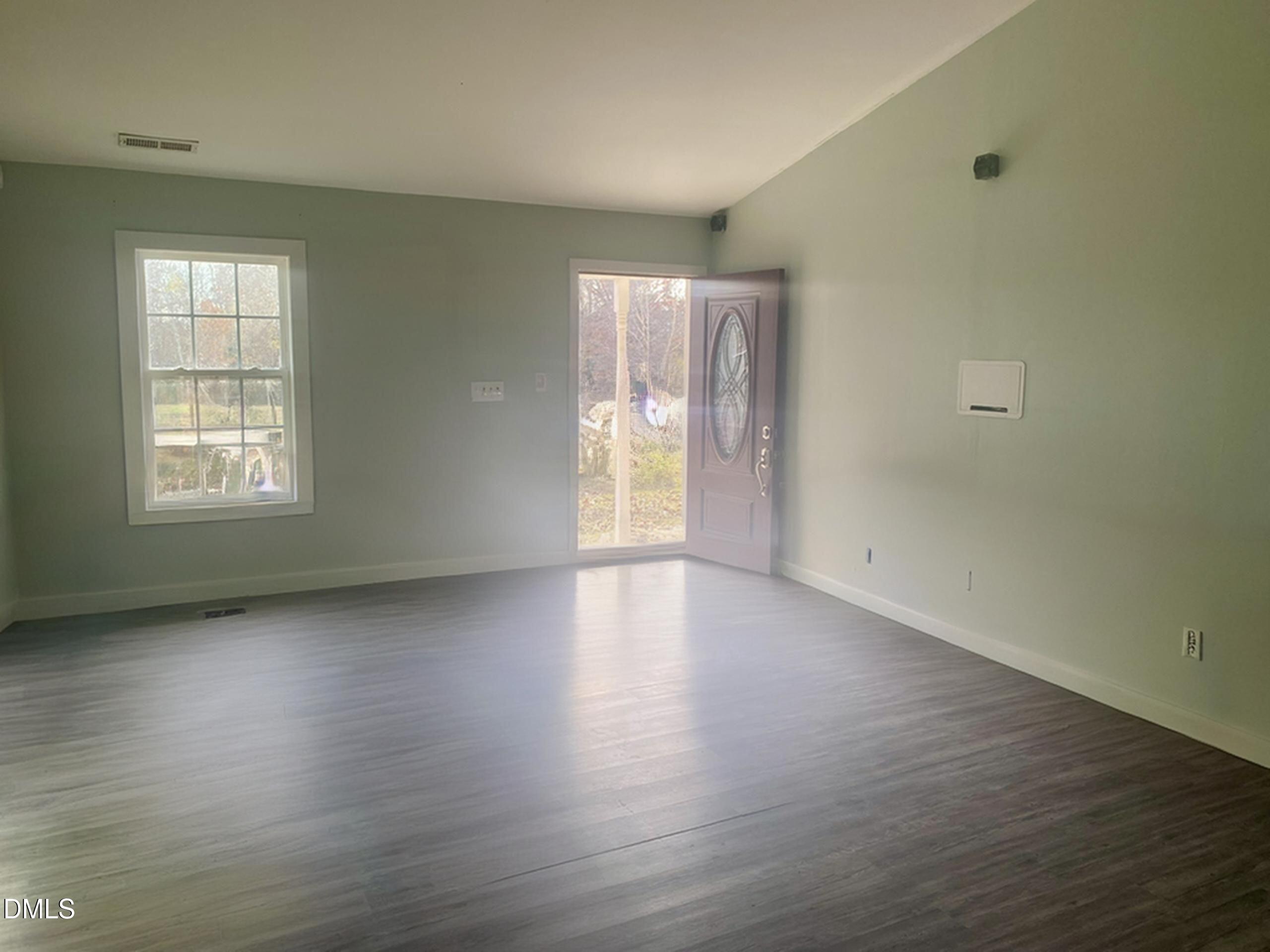 3182 Sims Bridge Road Kittrell, NC 27544 - Photo 4 of 44 an empty room with wooden floor and windows