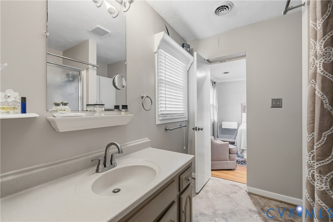 5800 West Rois Road Richmond, VA 23227 - Photo 17 of 32 a bathroom with a sink and a mirror