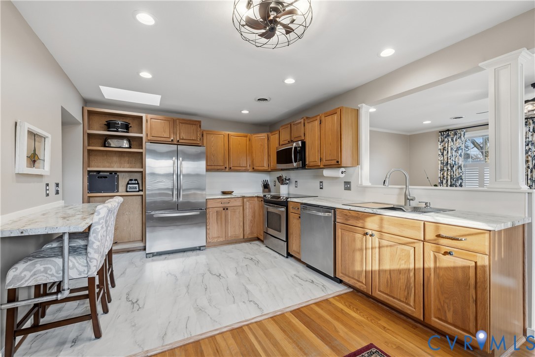 5800 West Rois Road Richmond, VA 23227 - Photo 8 of 32 a kitchen with stainless steel appliances kitchen island granite countertop a sink and cabinets
